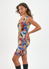 Woman wearing a colorful patterned dress on a white background